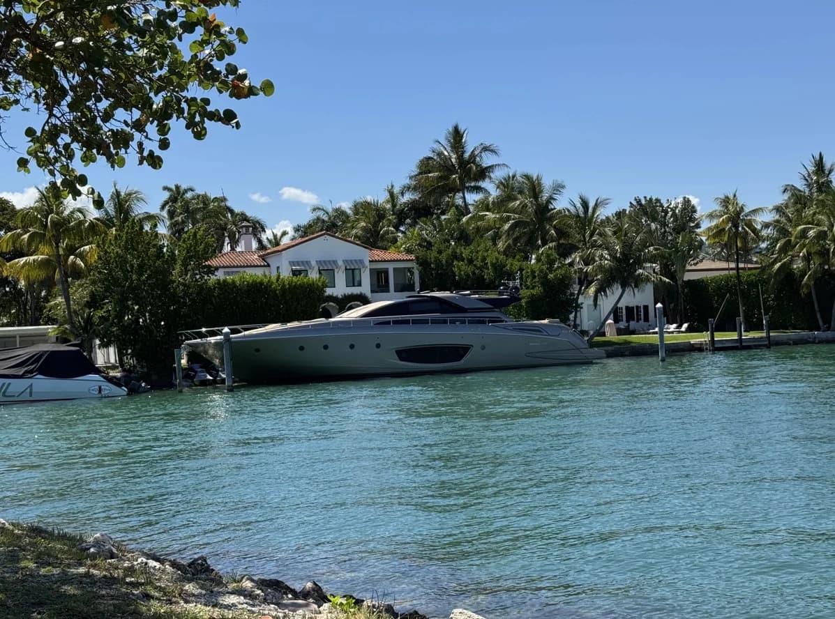 A Miami Beach waterfront home with a yacht outside